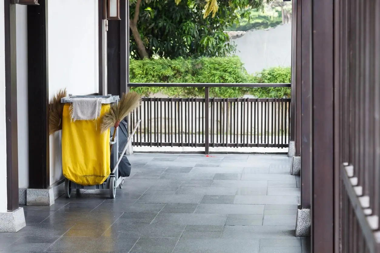 A person is standing in front of a balcony.